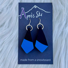 Blue and black earrings on a blue card with 'Après Ski' branding.